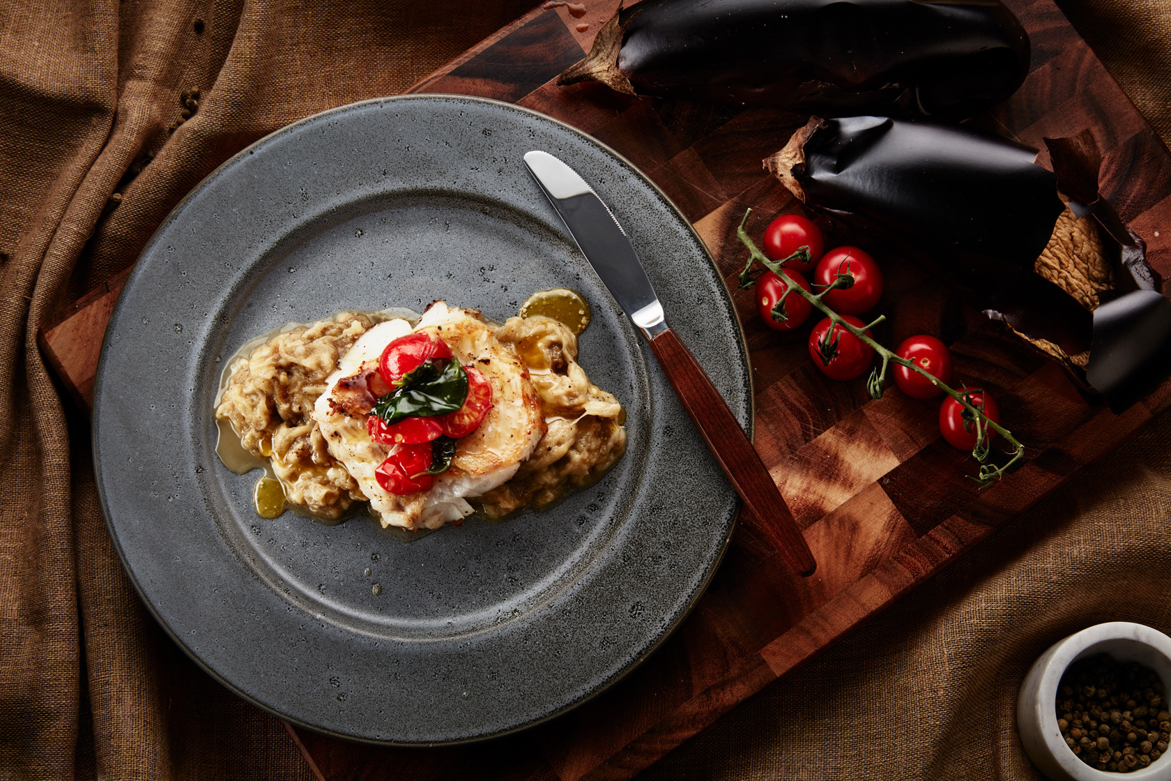 Fried skrei (winter cod) with basil butter and tomatoes