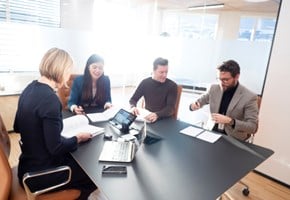 Employees together in a meeting room