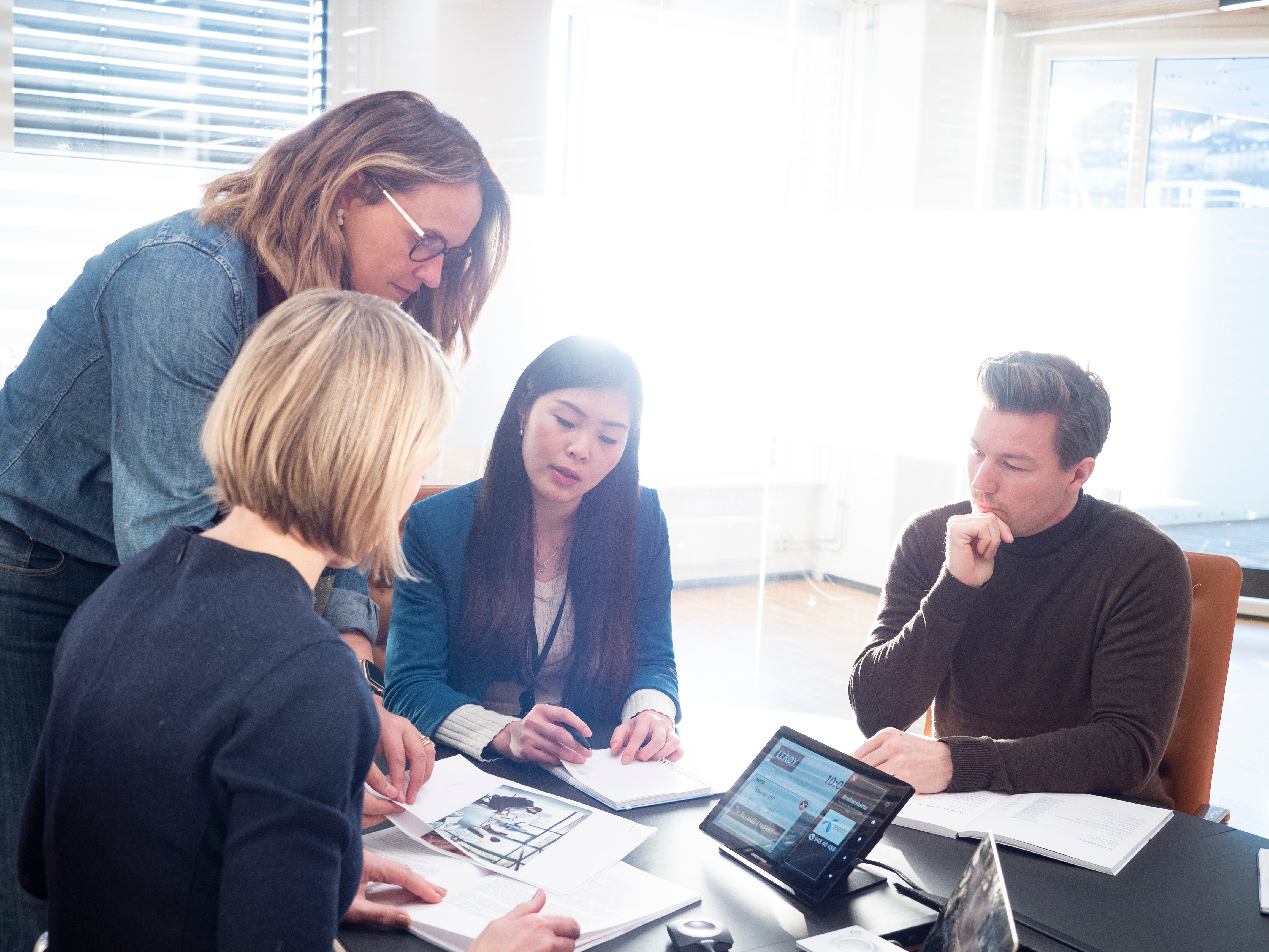 Office environment with people around a table