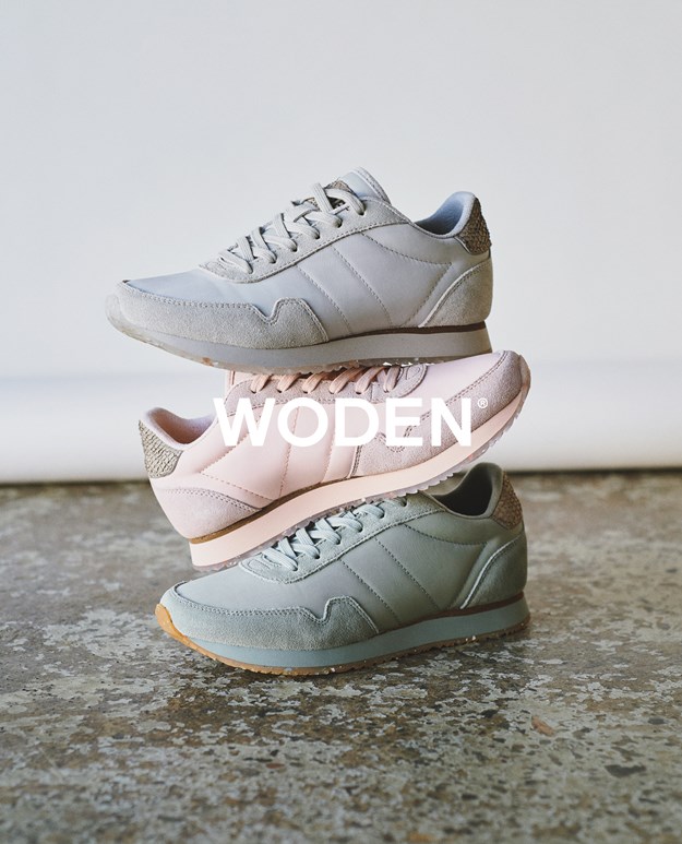 Three shoes standing on top of each other. All of the heels have a fish leather patch. In front is the word Woden, which is also the brand name. 