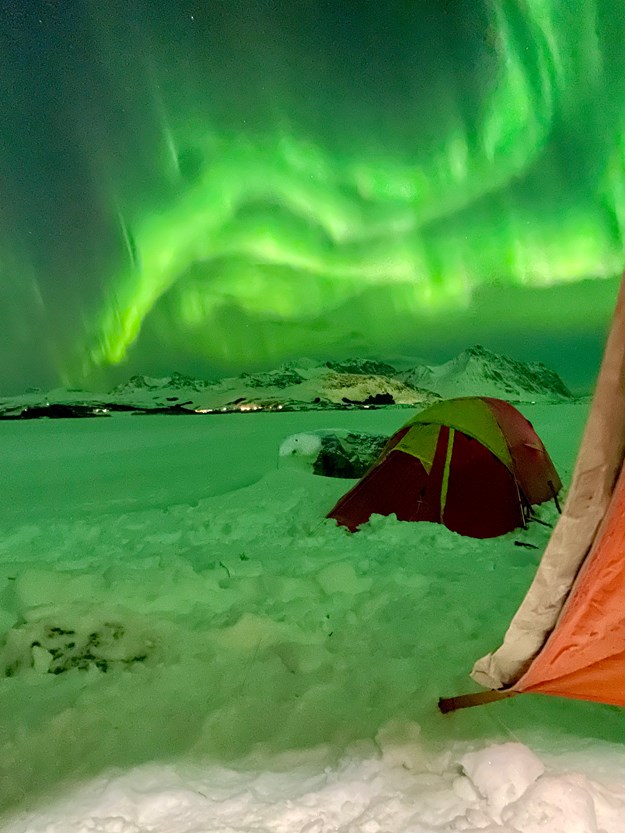 The sky dances in green colors, it is the northern lights in the north.