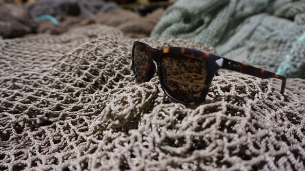 fishing line lying in the front in focus. In the back is skies, mountains and ocean blurry.