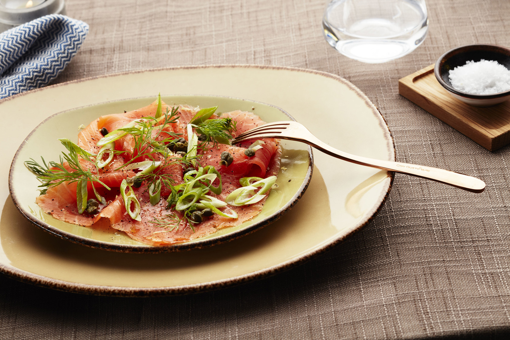Carpaccio of smoked trout served with spring onion and lemon