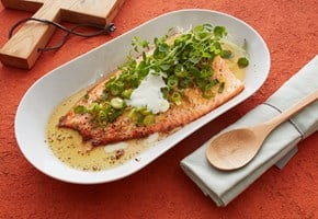Baked fillet of trout with spring onion and lemon