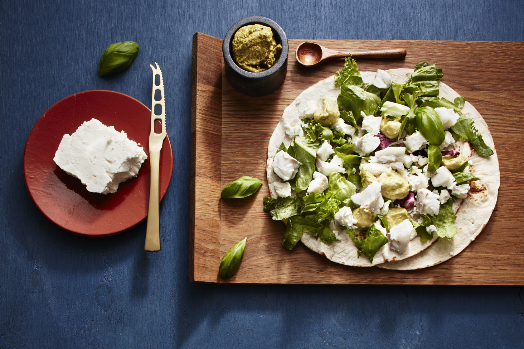 Wraps with cod, pesto mayonnaise,​ mixed salad and feta cheese​ ​